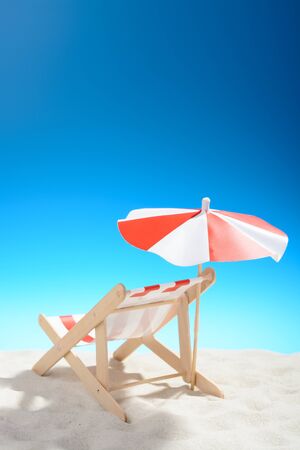 Deckchair on the beach on background of blue skyの写真素材