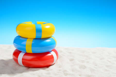 Swimming ring on the beach on background of blue sky