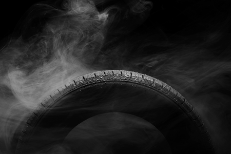 Car tire covered with water drops in the fogの写真素材