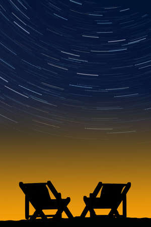 The silhouettes of the chairs on the background of sunriseの写真素材