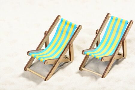 Two sunbeds on the beach: top view