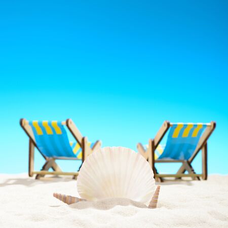 Seashell and two sunbeds at the beach on background of blue skyの写真素材