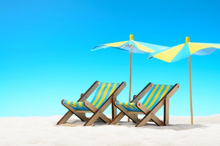 Two sunbeds at the beach on background of blue skyの写真素材