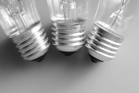 Three incandescent bulbs on grey backgroundの写真素材