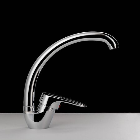 Water faucet on black backgroundの写真素材
