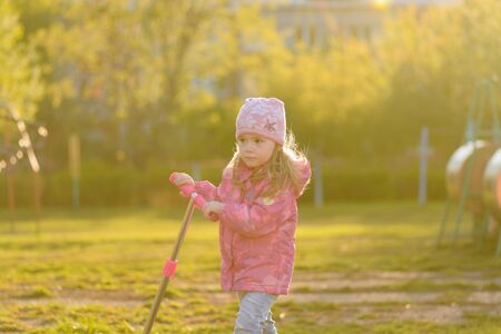 Little girl riding a scooterの写真素材