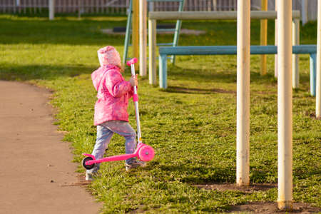 Little girl riding a scooterの写真素材