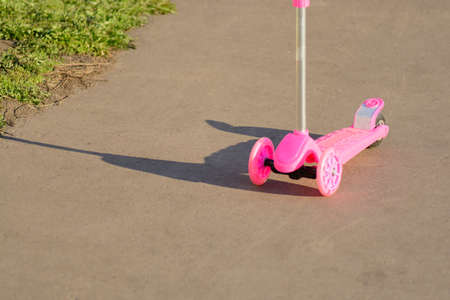 Pink scooter on the pavement