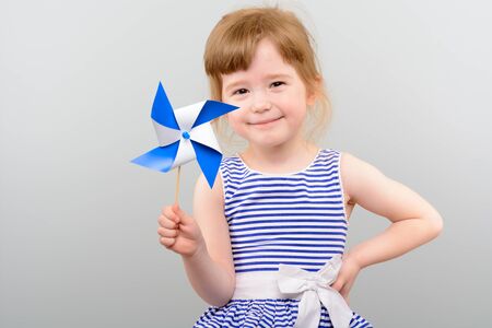 Cute girl with windmill toyの写真素材