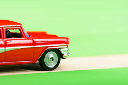 Red vintage car model on wooden boardsの写真素材