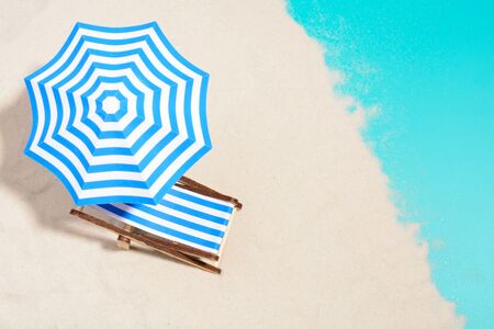 From above of lounge area on beach with striped chair under umbrella.の写真素材