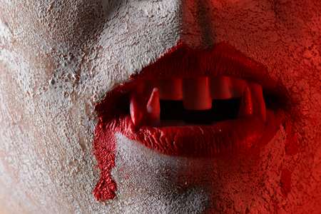 Bloody vampire fangs closeupの写真素材