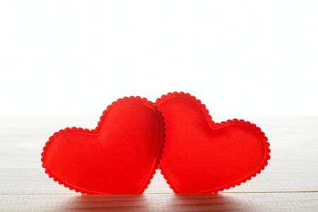 Two small fabric heart on tableの写真素材