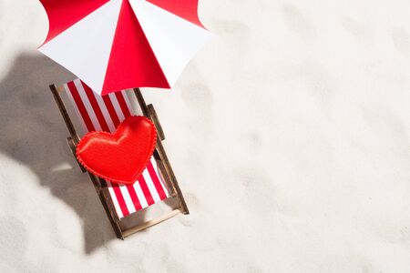 Little heart and chair for relaxing on the beachの写真素材