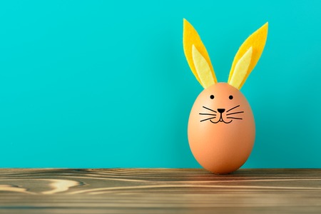 Creative Easter Bunny made from chicken eggs on grass