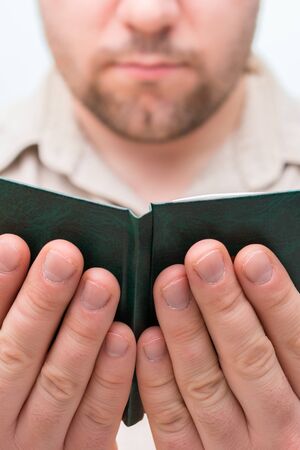 Muslim man praying, holding Quran ruqyah