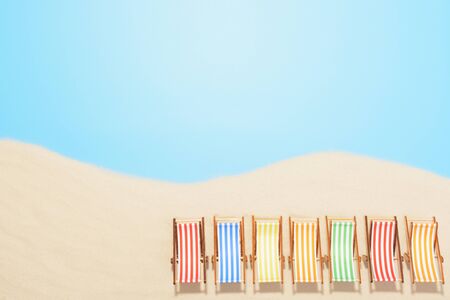 Aerial view of the beach resort with copy space. The concept of summer vacation. Multicolored sun loungers in a row on the sandの写真素材