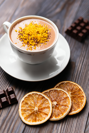 Top view of served sweet hot chocolate in white cup garnished with grated orange zestの写真素材