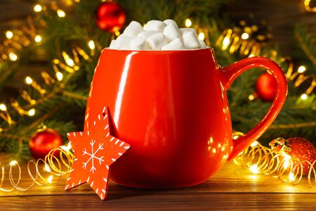 Marshmallows in a red mug with Christmas and New Year decorations. Holiday concept.の写真素材