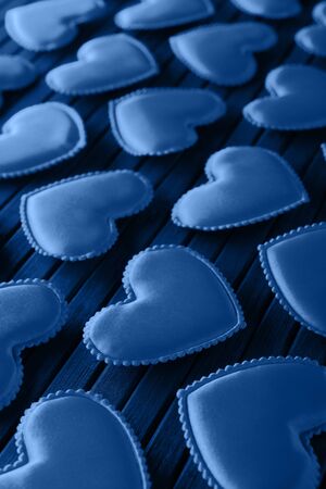 Hearts made of cloth on a bamboo leaf. Toning in trendy color 2020 classic blue.の写真素材