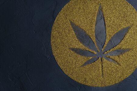 Hemp flour concept, top view. Scattered hemp flour in the form of a circle and a leaf on a dark concrete surface. Image contains copy space, horizontal orientation.の写真素材