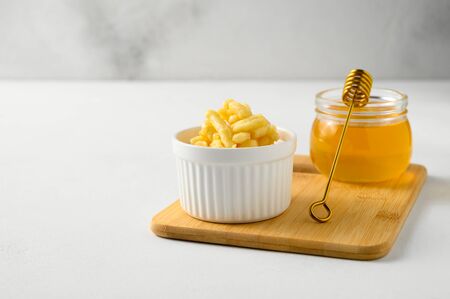 National food cuisine of the Middle East. White ramekin with chak chak and honey in a jar on a white table. Horizontal orientation, copy space.の写真素材