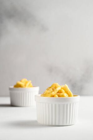 National food cuisine of the Middle East. Two ramekin with chak chak on a white table. Vertical orientation, copy space.の写真素材