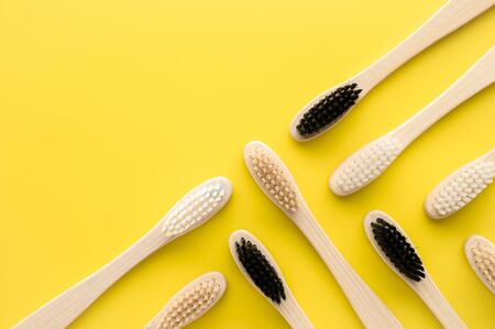 Zero waste concept. Group of eco natural bamboo toothbrushes on a bright yellow background. Flatlay, copy space, horizontal orientation. Layout natural organic hygiene products. no plasticの写真素材