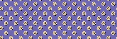 Lifestyle without plastic concept. Seamless pattern of natural loofah sponges on a purple background. Wide banner.の写真素材