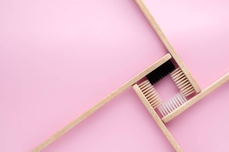 Zero waste and no plastic concept. Group of eco natural bamboo toothbrushes on a pastel pink surface. Top view, copy space, horizontal orientation. Layout natural organic hygiene products.の写真素材