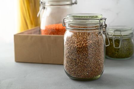 Donation box on the table. Food Delivery Concept. Jars with various cereals in a cardboard box. Copy space.の写真素材