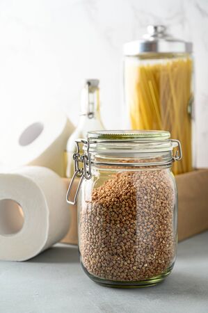 Donation box on the table. Food Delivery Concept. Jars with various cereals in a cardboard box. Copy space.の写真素材