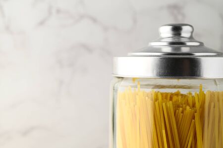 Spaghetti in a glass jar. Close-up, copy space.の写真素材