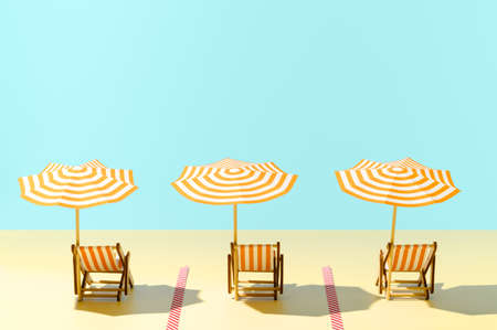 Beach with sunbeds and umbrellas time after the coronavirus pandemic. New normal concept. Keep safe social distance. Copy space, horizontal orientation.の写真素材