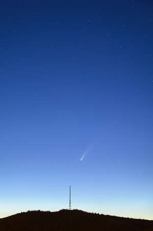 Antenna silhouette and Comet C/2020 F3 Neowise in the night sky.の写真素材