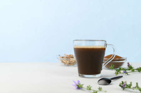 Alternative to coffee. Healthy drink chicory. Chicory coffee in a cup on a light gray table. space for text.の写真素材