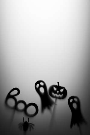 Halloween Decoration. Terrifying Shadow Puppets. Shadows pumpkin, ghost, spider, and Boo word on the gray background. Copy space vertical orientation.の写真素材