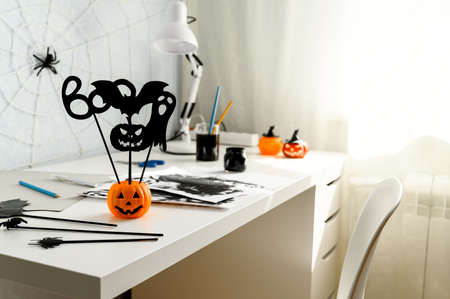 Preparing for Halloween. DIY concept. Halloween decorations on a white desk, indoors. Daytime. Copy space.の写真素材