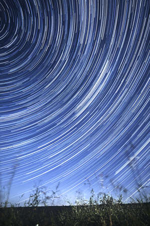 Concentric star tracks in the night sky. startrails. Vertical orientation.の写真素材