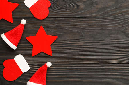 Top view of Christmas decorations on a dark wooden background. Minimal Christmas concept. Flat lay, copy space.の写真素材