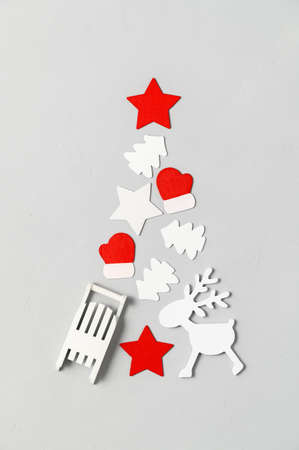 Alternative Christmas tree. Top view of Christmas tree made from different wooden decoration on a light gray background. Vertical orientation, flat lay.の写真素材