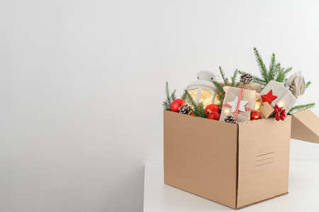 Christmas gifts in eco-friendly reusable packaging and decorations in a cardboard box. Delivery and donation concept. Selective focus. Copy spaceの写真素材