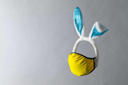 New normal Easter holiday concept. Creative levitation composition with cyan bunny ears headband and...