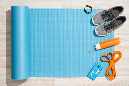 Sports background. Equipment for training and outfit under morning sunlight on wooden floor.の写真素材
