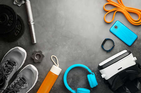 VR technology and Workout concept. Sports equipment on dark gray backgroundの写真素材