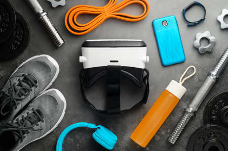 VR technology and Workout concept. Sports equipment on dark gray backgroundの写真素材