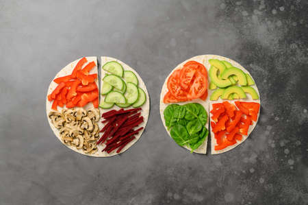 Vegetarian Tortillas with different fillings of mushrooms and fresh vegetables. Food trend. Trendy...
