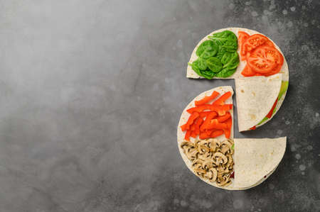 Vegetarian Tortillas with different fillings of mushrooms and fresh vegetables. Food trend. Trendy...