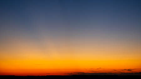 Vibrant and colorful minimalistic landscape. Scenic view of the dramatic sky during sunset. Empty...