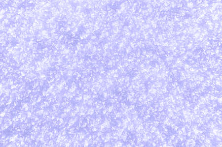 Snowy background in the main trendy Very Peri Color Of The Year 2022. Close-up of snowflakes texture.の写真素材